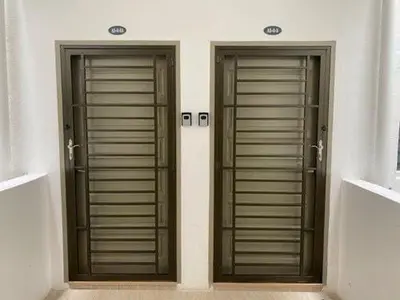 two wooden doors on the side of a building at City Retreat at Quintet(3BR/8pax) 9 Jalan PMCJ, Tanah Rata in Tanah Rata