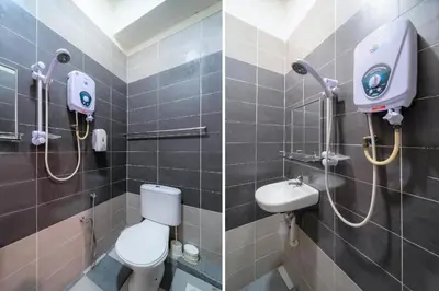 a bathroom with a toilet and a sink at Hotel O My Budget Home in Batu Ferringhi