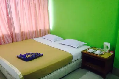 a bedroom with a bed with a green wall at F Hotel Bayan Lepas in Bayan Lepas