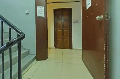 a hallway with a door and stairs in a building at F Hotel Bayan Lepas in Bayan Lepas