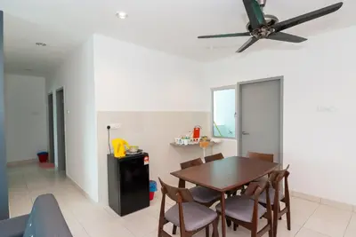 a dining room with a table and a ceiling fan at Ipoh Town P Kepayang in Ipoh
