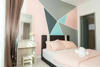 a bedroom with a bed and a geometric wall at Ipoh Town P Kepayang in Ipoh