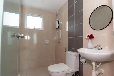 a bathroom with a toilet and a sink and a mirror at Ipoh Town P Kepayang in Ipoh