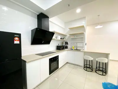 a kitchen with white cabinets and a black refrigerator at JOVIAL Modern Cozy Suite `Metropol BM BandarPerda in Bukit Mertajam