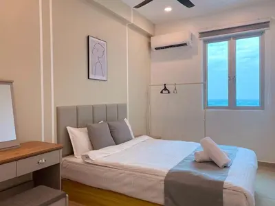 a bedroom with a bed and a television and a window at JOVIAL Modern Cozy Suite `Metropol BM BandarPerda in Bukit Mertajam
