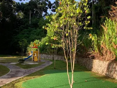 a woman sitting on a playground in a park at Highland Green at Quintet (3BR/ 8pax) in Tanah Rata