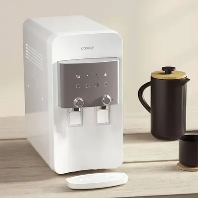 a white coffee maker sitting on a table next to a cup at Highland Green at Quintet (3BR/ 8pax) in Tanah Rata