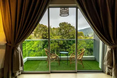 a room with a large window with a table and chairs at Highland Green at Quintet (3BR/ 8pax) in Tanah Rata