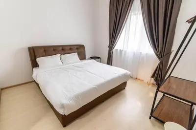 a bedroom with a bed and a large window at Highland Green at Quintet (3BR/ 8pax) in Tanah Rata