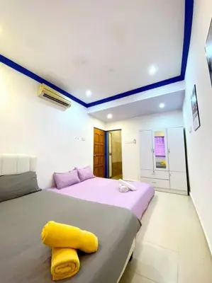 a bedroom with a bed with a yellow towel on it at (TN)Modern Stylish 2 Storey Corner House @Alma BM in Bukit Mertajam