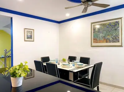 a dining room with a table and chairs and a ceiling fan at (TN)Modern Stylish 2 Storey Corner House @Alma BM in Bukit Mertajam