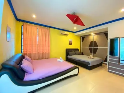 a bedroom with a bed and a couch and a tv at (TN)Modern Stylish 2 Storey Corner House @Alma BM in Bukit Mertajam