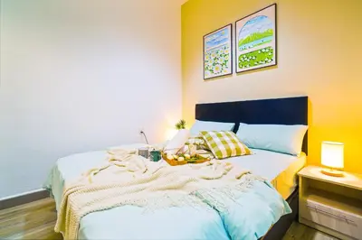 a bedroom with a bed with a bowl of fruit on it at The Octagon Ipoh -- In the Heart of the City in Ipoh