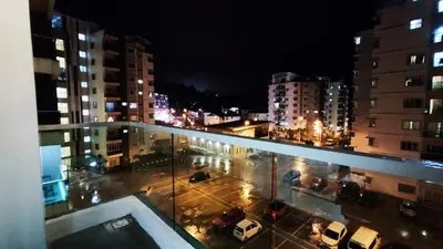 a view of a city at night from a balcony at A ONE Holiday Apartment-Quintet in Cameron Highlands