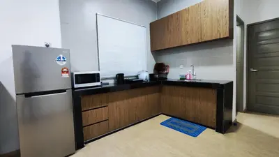 a kitchen with a refrigerator and a counter top at A ONE Holiday Apartment-Quintet in Cameron Highlands