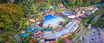 an aerial view of an amusement park with a water park at Unique Boho Style Condo with NETFLIX for up to 5PAX - Enjoy Mountain View while swimming at the Infinity Pool & Natural Hotspring Pool, 2mins walk to the Lost World of Tambun, Water Themepark at IPOH in Ipoh