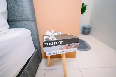 two boxes on a table next to a bed at Swing & Pillows - Penang Road, Georgetown Penang in George Town