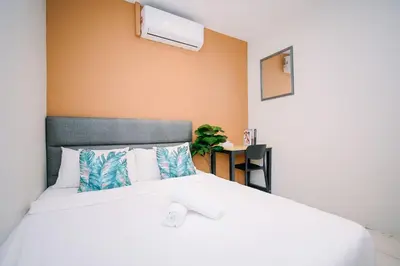 a bedroom with a bed with white sheets and pillows at Swing & Pillows - Penang Road, Georgetown Penang in George Town