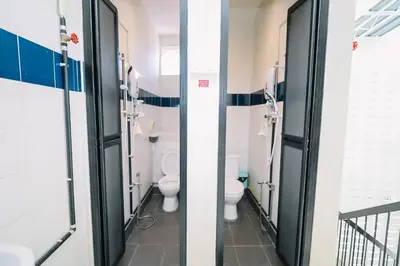 a bathroom with two toilets in a building at Swing & Pillows - Penang Road, Georgetown Penang in George Town