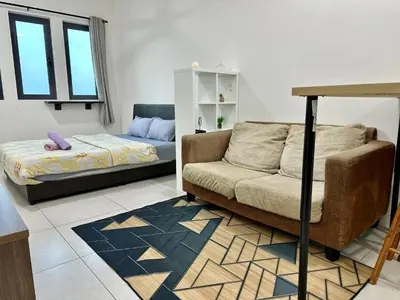 a living room with a couch and a bed at Dreamy Cozy Studio Meritus Residensi Perai in Perai