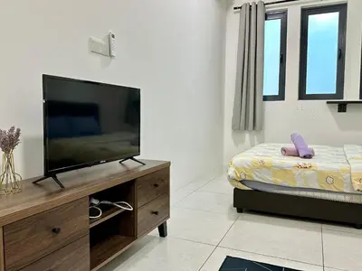 a bedroom with a flat screen tv and a bed at Dreamy Cozy Studio Meritus Residensi Perai in Perai