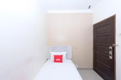 a small bedroom with a red pillow on a bed at Spring Inn Hotel in Sungai Petani