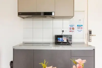 a kitchen with a counter top with a toaster oven at Suites Bayan Lepas in Bayan Lepas
