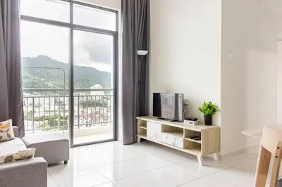 a living room with a tv and a large window at Suites Bayan Lepas in Bayan Lepas