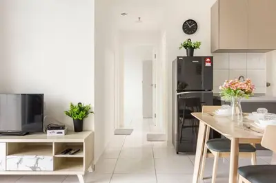 a kitchen and dining room with a table and a television at Suites Bayan Lepas in Bayan Lepas