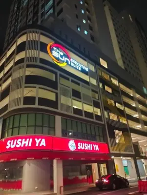 a building with a sign on the side of it at Suites Bayan Lepas in Bayan Lepas