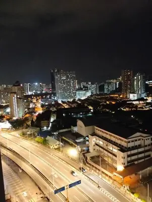 a city skyline at night with a highway and buildings at Suites Bayan Lepas in Bayan Lepas
