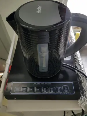 a black coffee pot sitting on top of a microwave at Cozy n Quiet home near to BKE Highway n Kulim High Tech Park in Lunas