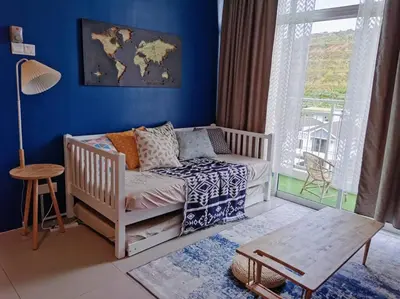 a baby room with a crib and a blue wall at WingsNest Cameron Town Night Market High Speed Wi-Fi in Tanah Rata