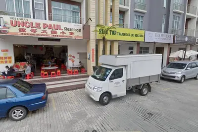 a white truck parked in front of a building at WingsNest Cameron Town Night Market High Speed Wi-Fi in Tanah Rata