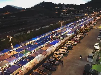 a parking lot with rows of cars and tents at WingsNest Cameron Town Night Market High Speed Wi-Fi in Tanah Rata