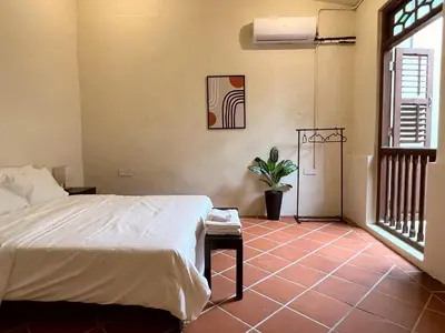 a bedroom with a bed and a potted plant at Aayu Stewart - Stewart Ln, George Town in George Town