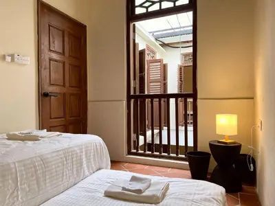 a room with a bed and a window with a door at Aayu Stewart - Stewart Ln, George Town in George Town