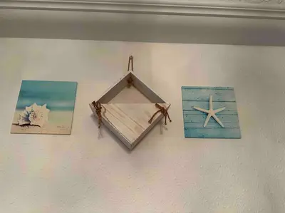 a mirror hanging on a wall with pictures on it at AAA Homestay Georgetown Penang in Ayer Itam