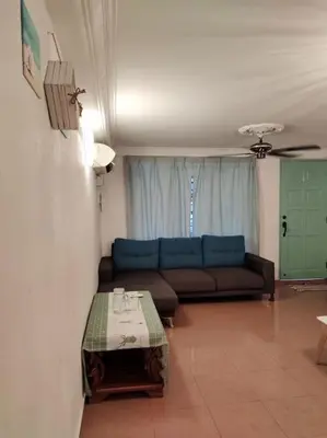a living room with a couch and a table at AAA Homestay Georgetown Penang in Ayer Itam
