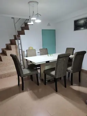 a dining room with a table and chairs and stairs at AAA Homestay Georgetown Penang in Ayer Itam
