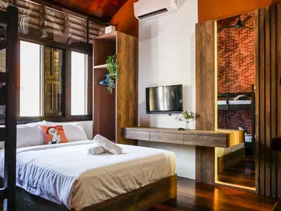 a bedroom with a bed and a tv on the wall at Carnarvon Antique Loft in George Town