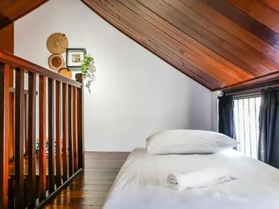 a bedroom with a bed and a wooden ceiling at Carnarvon Antique Loft in George Town
