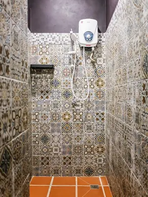 a bathroom with a shower with a toilet and a camera at Carnarvon Antique Loft in George Town