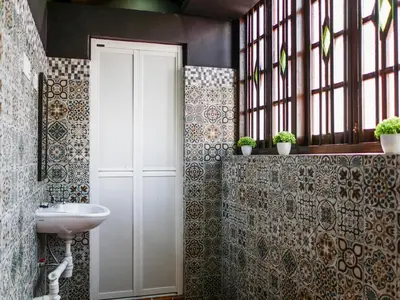 a bathroom with a sink and a white door at Carnarvon Antique Loft in George Town