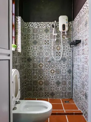 a bathroom with a shower with a toilet and a sink at Carnarvon Antique Loft in George Town