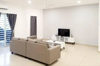 a living room with a couch and a tv at JOVIAL COZY&STYLISH 2STORYHOUSE 4ROOM@BMJURU in Bukit Mertajam