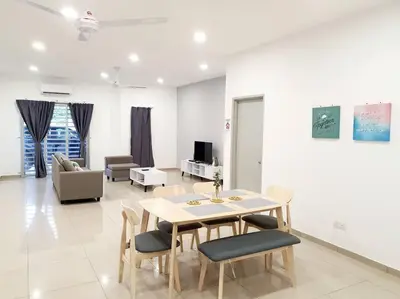 a dining room with a table and chairs in a living room at JOVIAL COZY&STYLISH 2STORYHOUSE 4ROOM@BMJURU in Bukit Mertajam