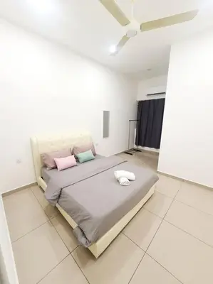 a bedroom with a bed with pink and blue pillows at JOVIAL COZY&STYLISH 2STORYHOUSE 4ROOM@BMJURU in Bukit Mertajam