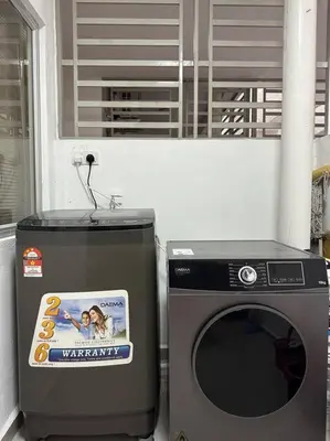 a washer and dryer next to a washing machine at Ulike Homestay-3Room-4 king Size Bed-The Venus in Sitiawan