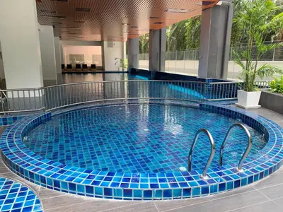 a swimming pool with blue tiles in a building at Ulike Homestay-3Room-4 king Size Bed-The Venus in Sitiawan